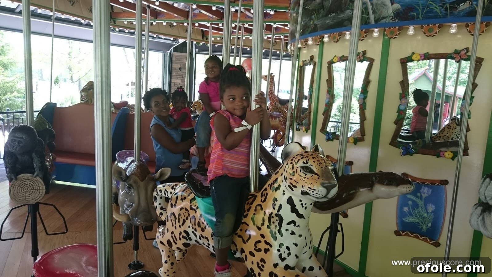 Family enjoying a fun ride at the zoo, laughing and smiling.