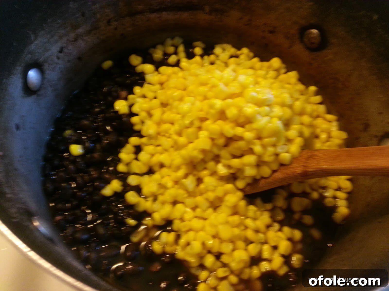 Corn and beans combined in a pot, simmering