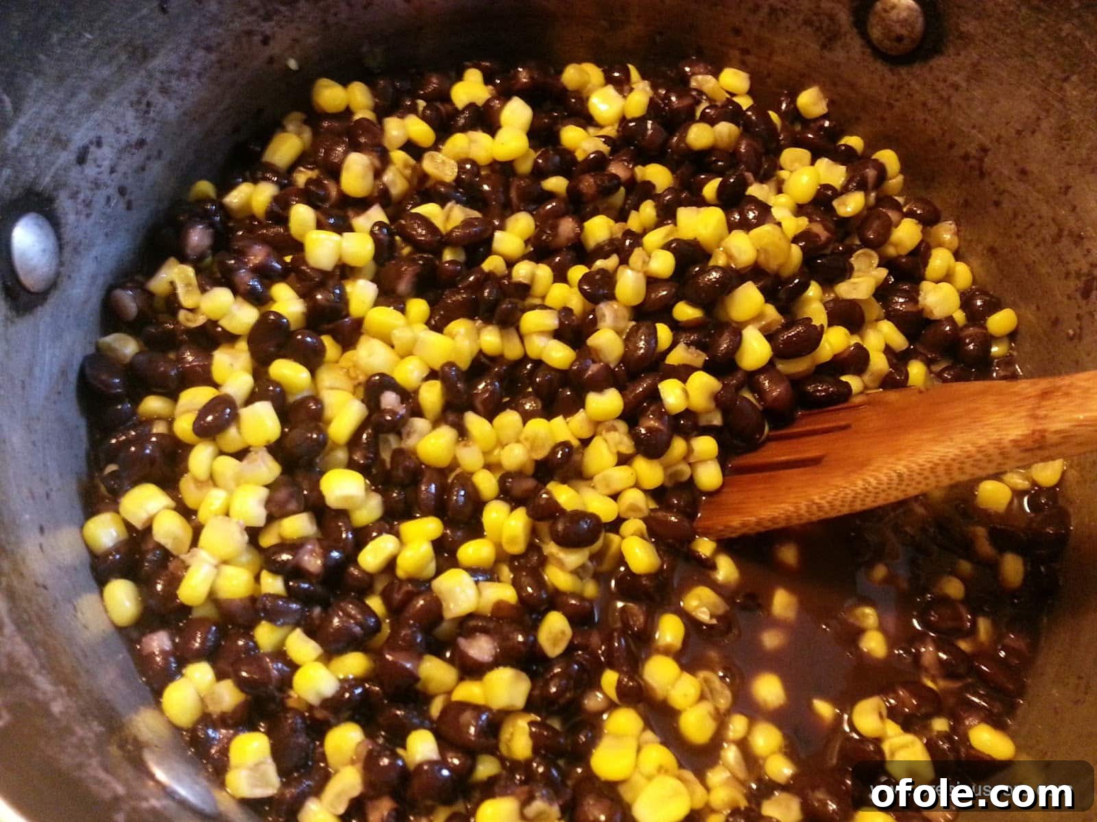 Corn and beans simmering gently in a pot