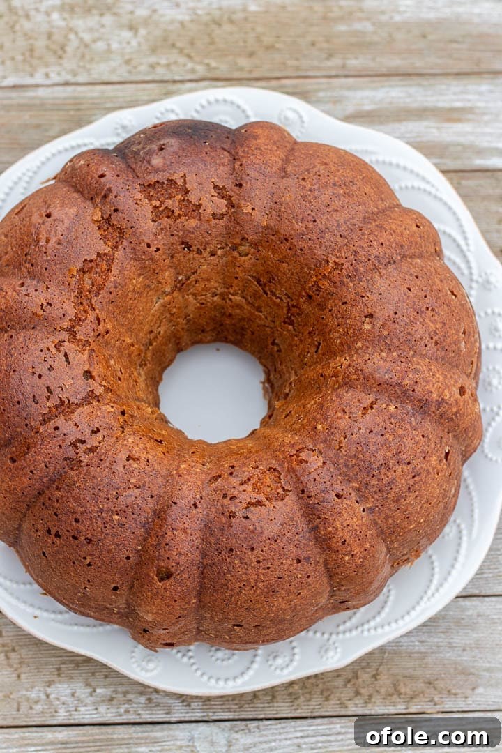 Moist Banana Bundt Cake 3 A freshly baked, golden banana cake cooling in an intricately designed bundt pan.