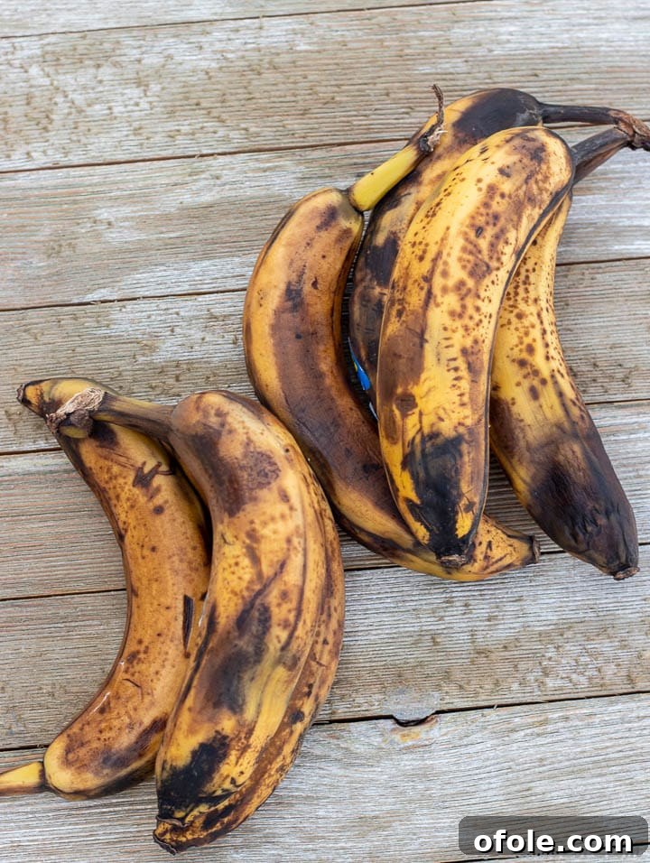 Moist Banana Bundt Cake 4 A cluster of perfectly overripe bananas with dark brown spots, ideal for baking delicious banana bread.