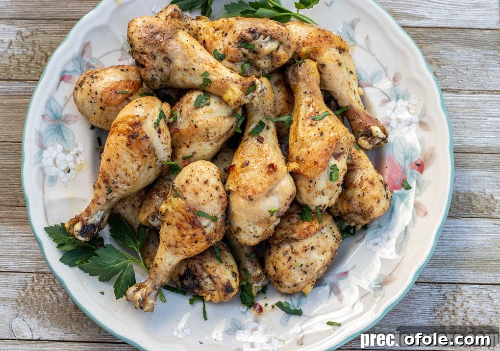 Extra Crispy Oven Baked Chicken Drumsticks 7 Oven baked chicken drumsticks or legs on a serving platter, beautifully browned.