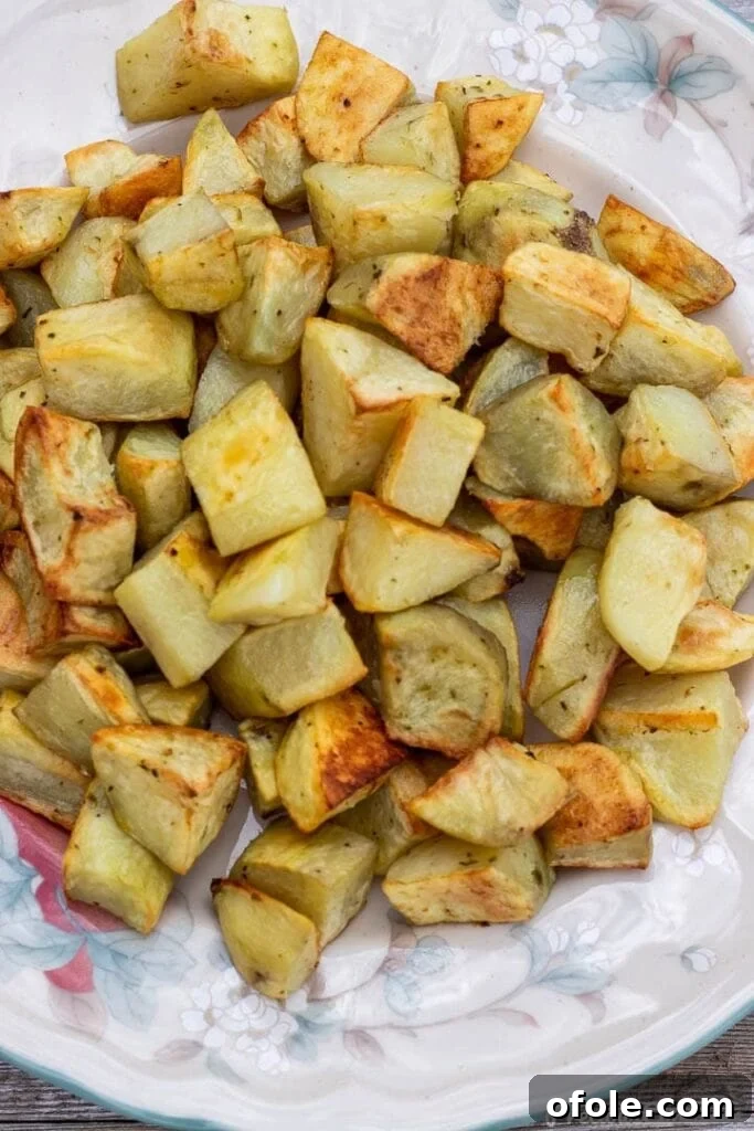 Effortless Roasted Potatoes 2 golden brown crispy roasted potatoes on a platter