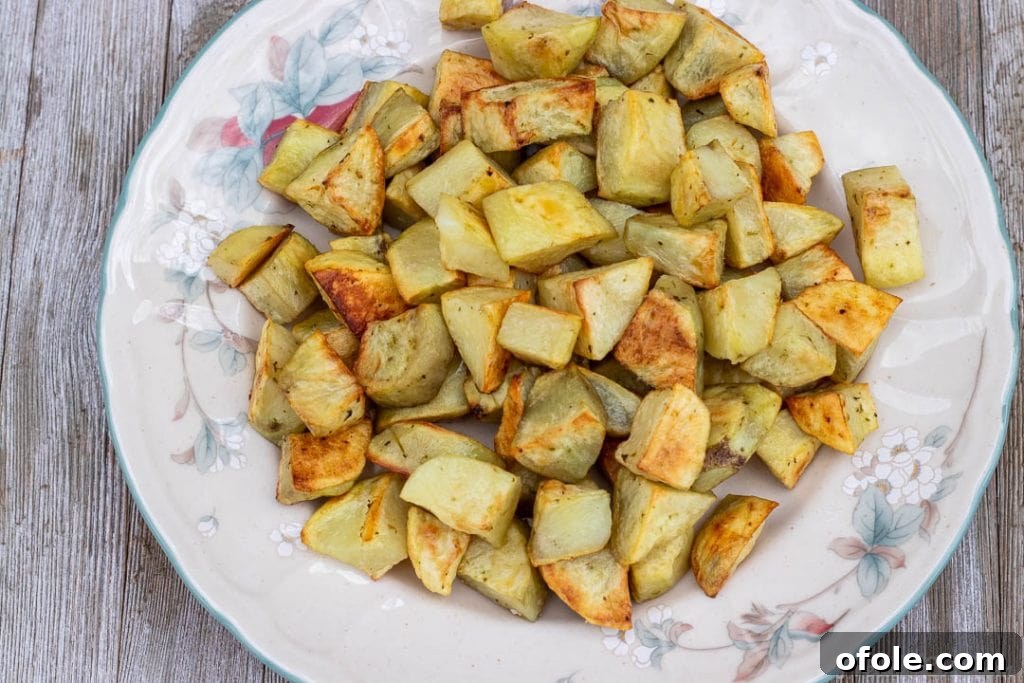 Effortless Roasted Potatoes 3 oven roasted potatoes on a serving platter