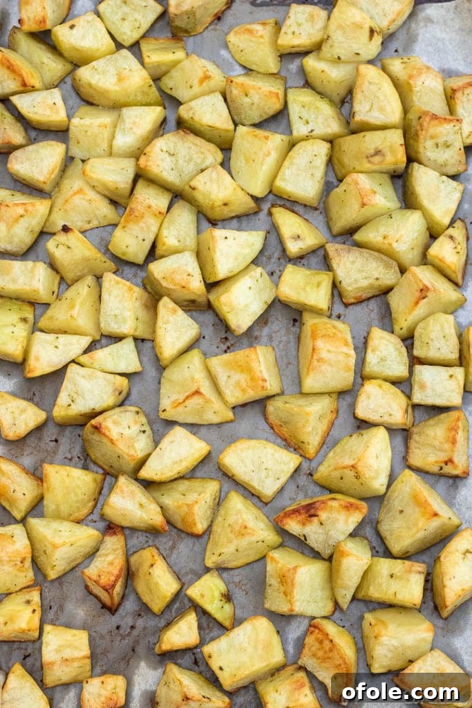 Effortless Roasted Potatoes 4 easy roasted potatoes on baking sheet lined with parchment paper