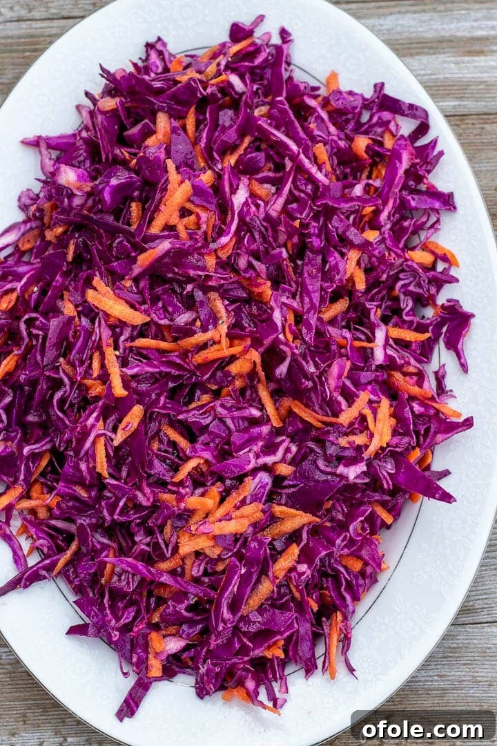 red cabbage slaw on a platter, showcasing its vibrant purple color and fresh texture