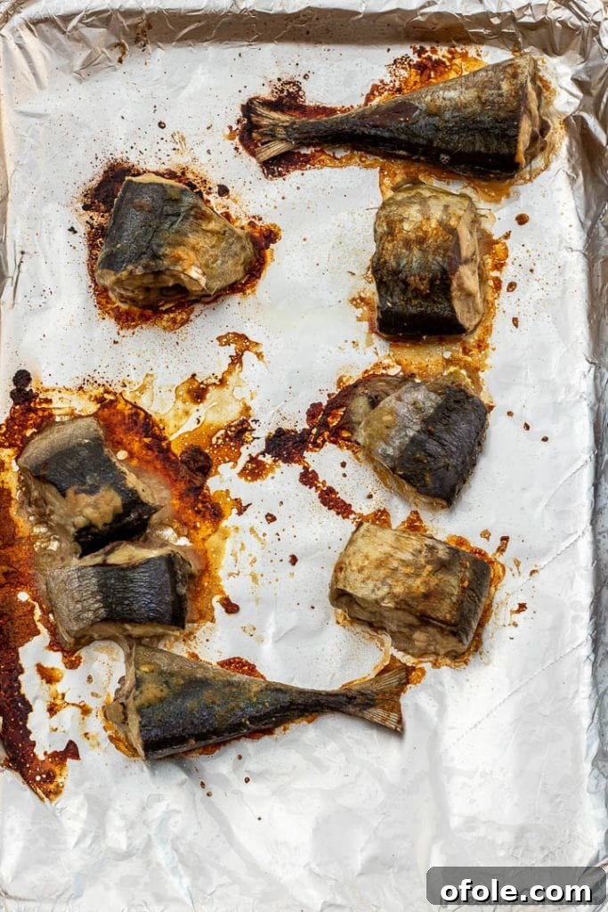 Baked fish steaks on a baking sheet, golden brown and ready for the stew