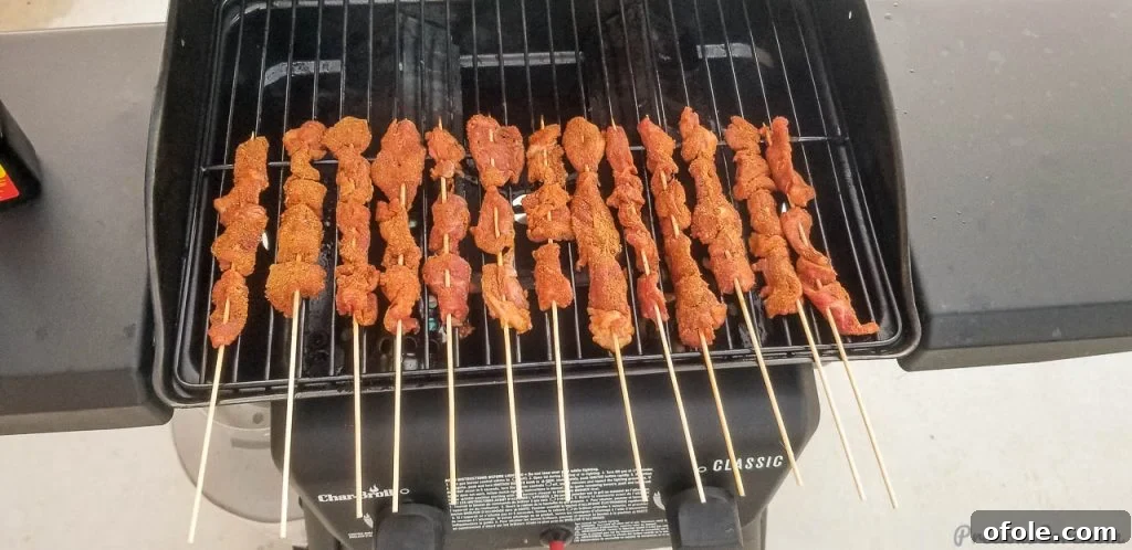 Beef skewers grilling over an open flame, preparing traditional Soya