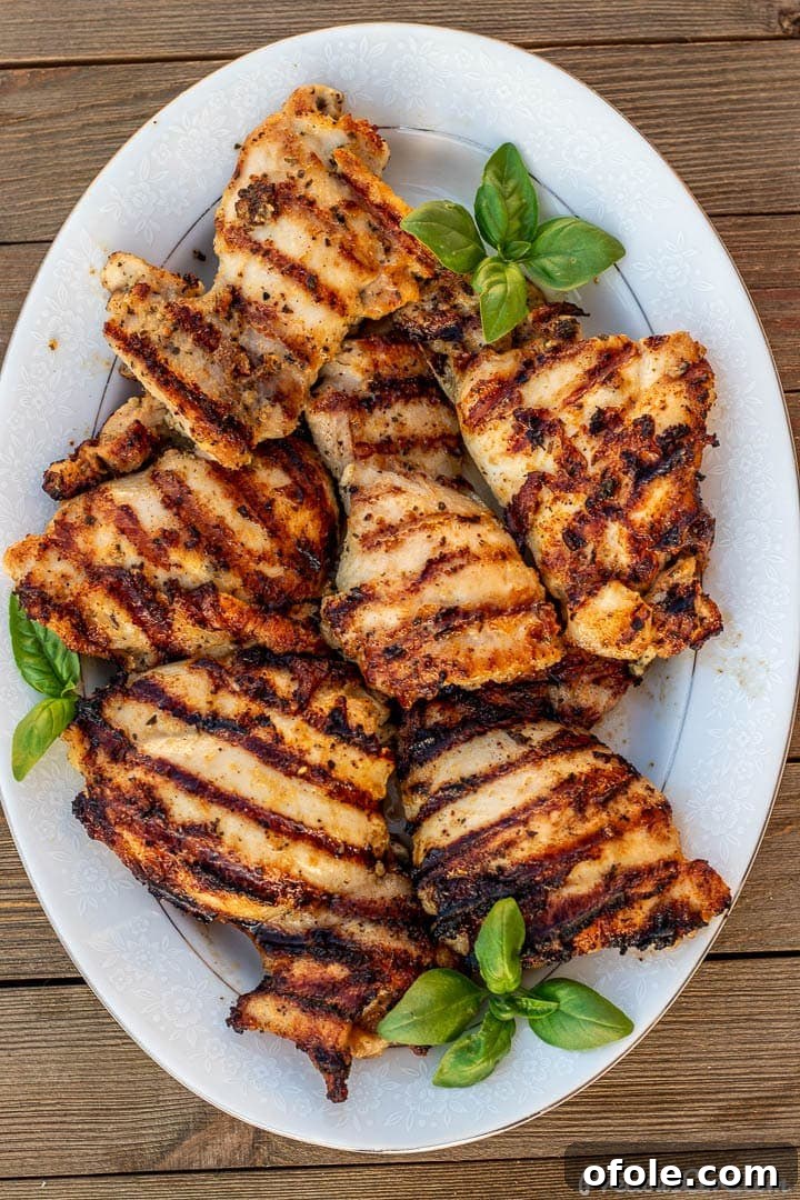 Succulent Grilled Boneless Chicken Thighs 2 grilled boneless chicken thighs on a platter