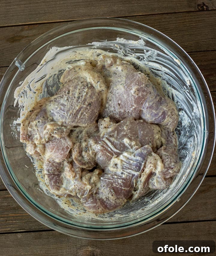 Succulent Grilled Boneless Chicken Thighs 4 Chicken thighs marinating in yogurt