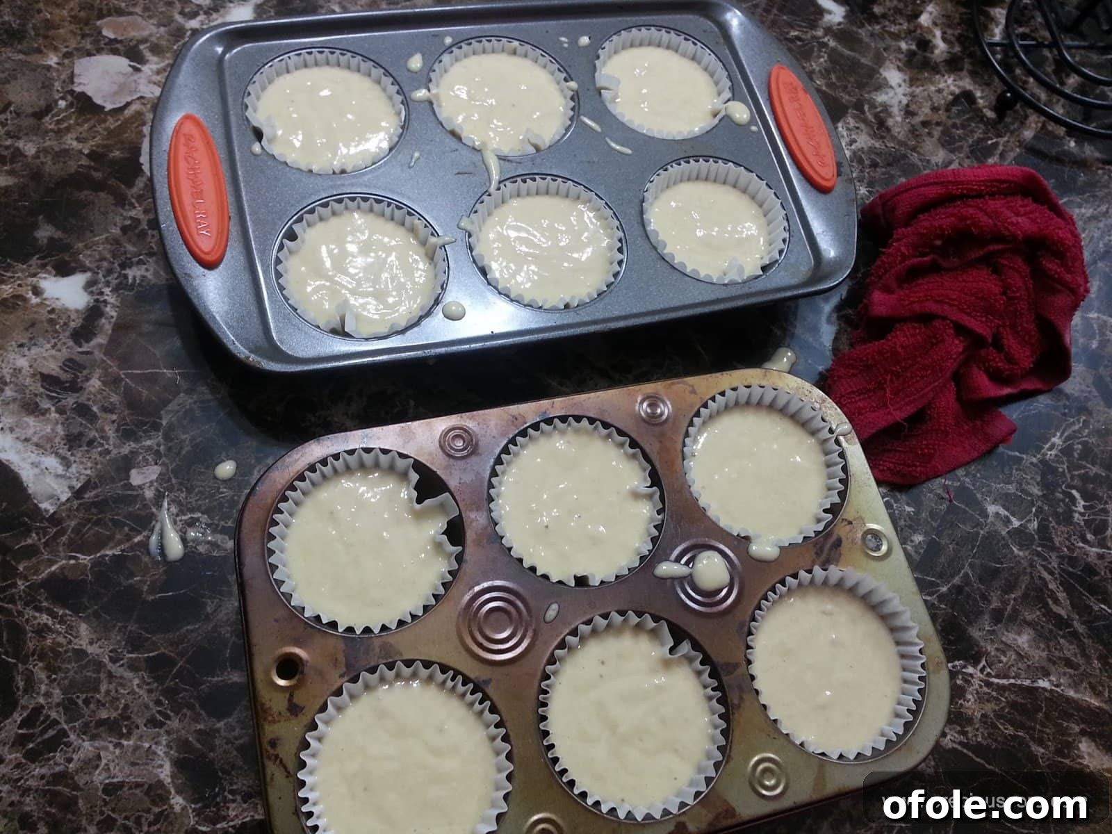 Muffin pans filled with banana cake batter.