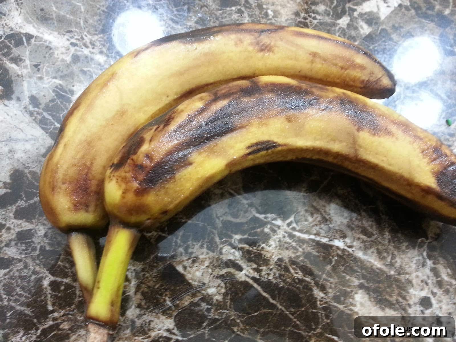 Overripe bananas showing brown spots, ready for baking.