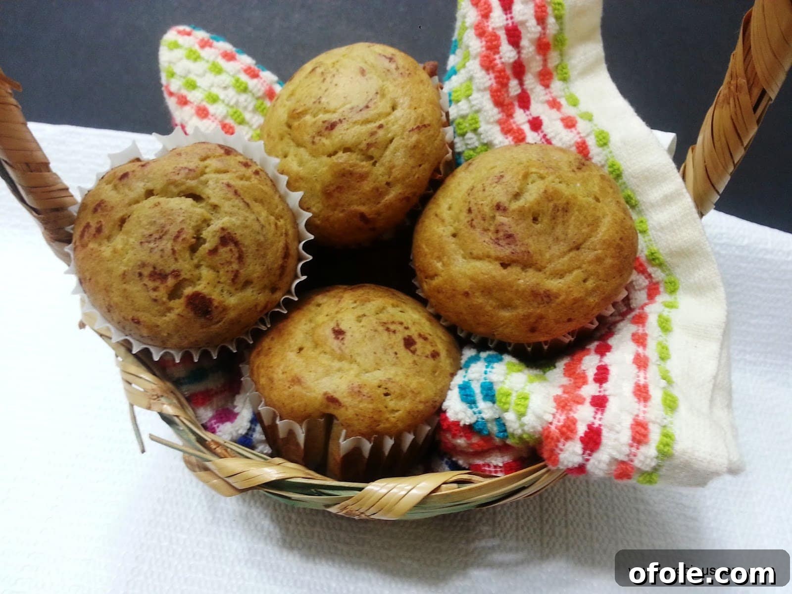 Cameroon banana cakes arranged beautifully on a washcloth in a rustic basket.