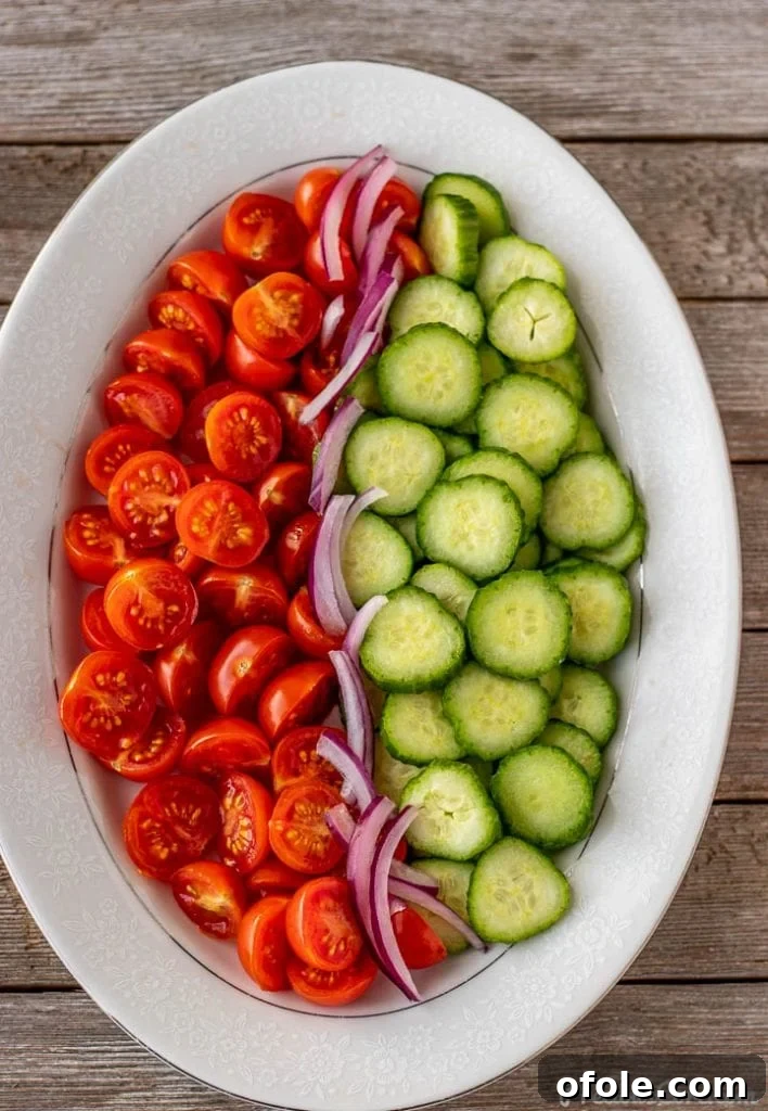 Zesty Cucumber Tomato Onion Medley 4 Finely chopped cucumbers, tomatoes, and red onions prepared for the salad.