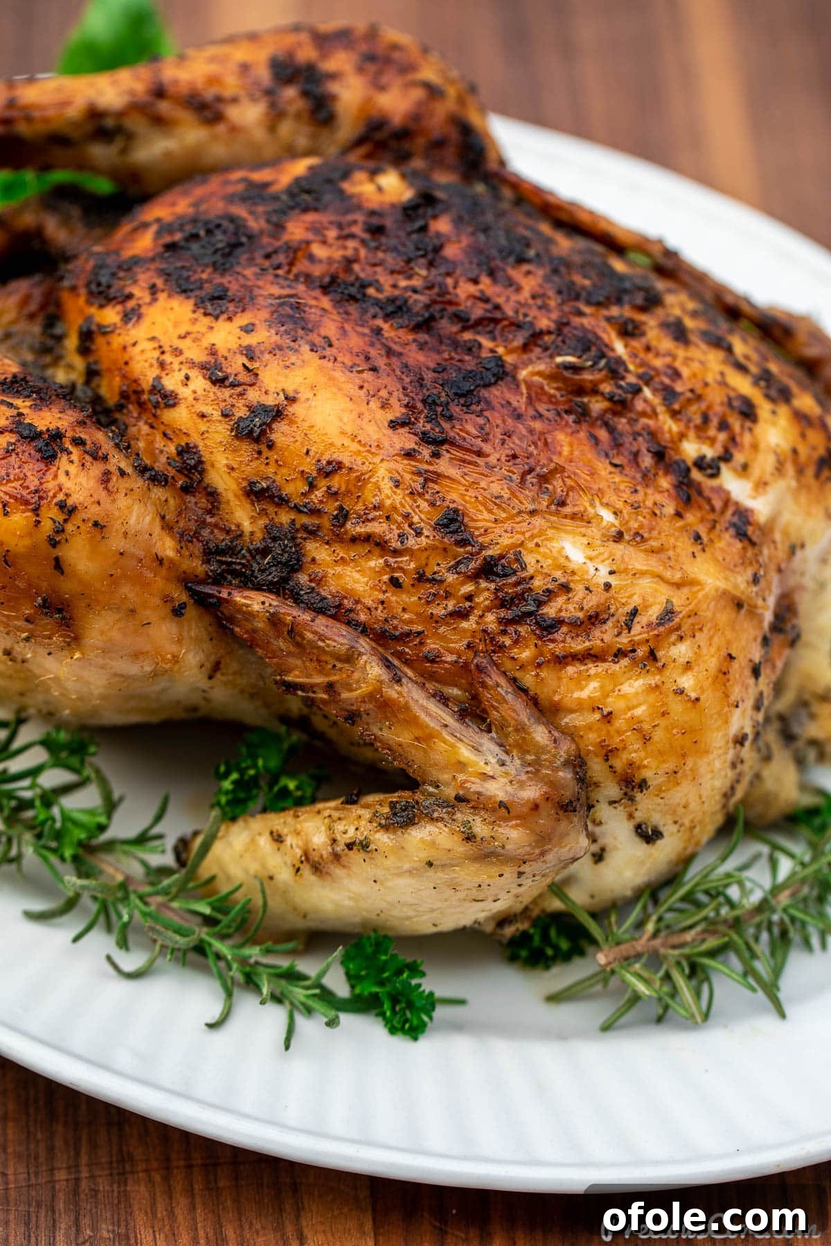 Savory Herb Roasted Chicken 3 Close-up shot showing one side of golden, crispy roasted chicken.