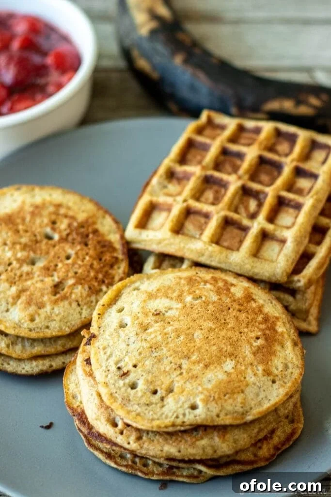 A serving plate featuring fluffy plantain pancakes and golden plantain waffles, beautifully garnished.