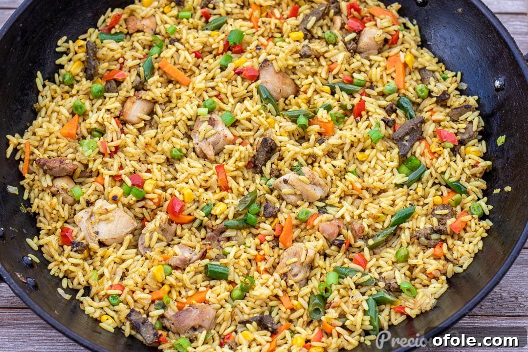 Vibrant African Fried Rice 5 Wok of fried rice with chicken and liver, ready to serve