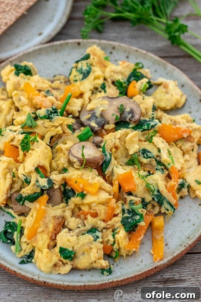 Vibrant Veggie Scramble 2 Vibrant vegetable scrambled eggs on a plate, ready to be enjoyed.