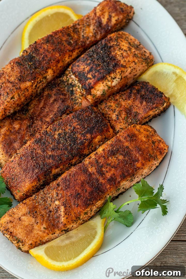 Pan-Seared Golden Salmon 2 Four grilled salmon fillets on a serving platter