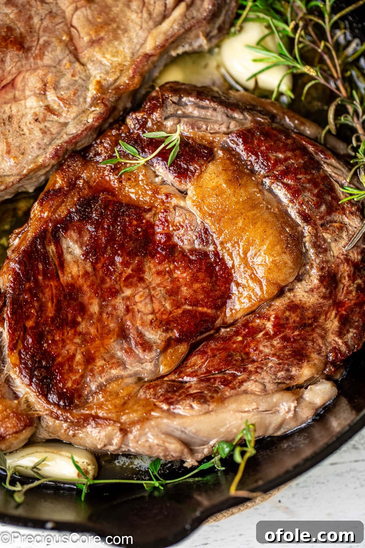 Crispy Seared Ribeye Perfection 9 Another close-up of a perfectly cooked pan-seared ribeye steak, showcasing the rich marbling and caramelized exterior.