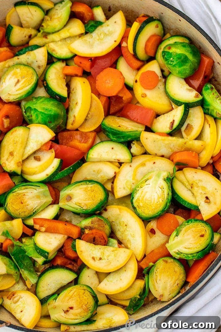 Vibrant sautéed vegetables in a large braiser pan, ready to serve, showcasing a medley of colors and textures.