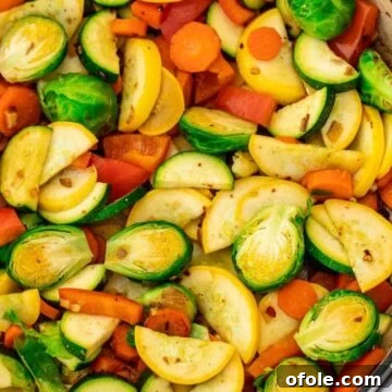 Sautéed vegetables in a braiser, appealing and ready to eat, garnished with fresh herbs.