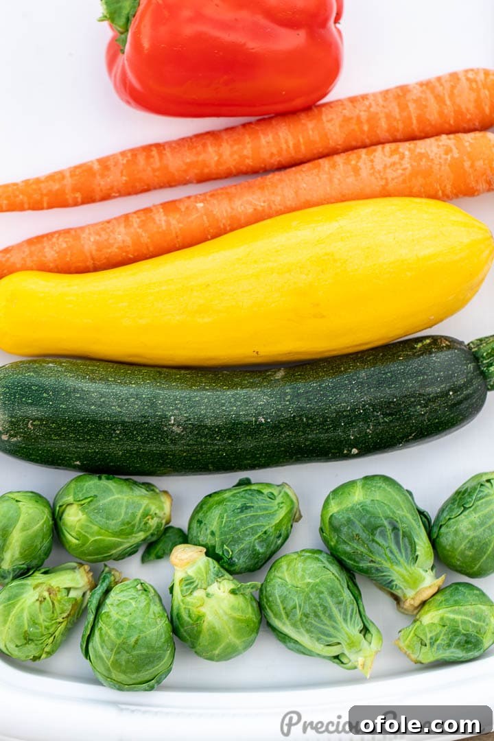 A colorful assortment of fresh vegetables, including bell peppers, zucchini, and carrots, beautifully laid out on a wooden cutting board, ready for preparation.