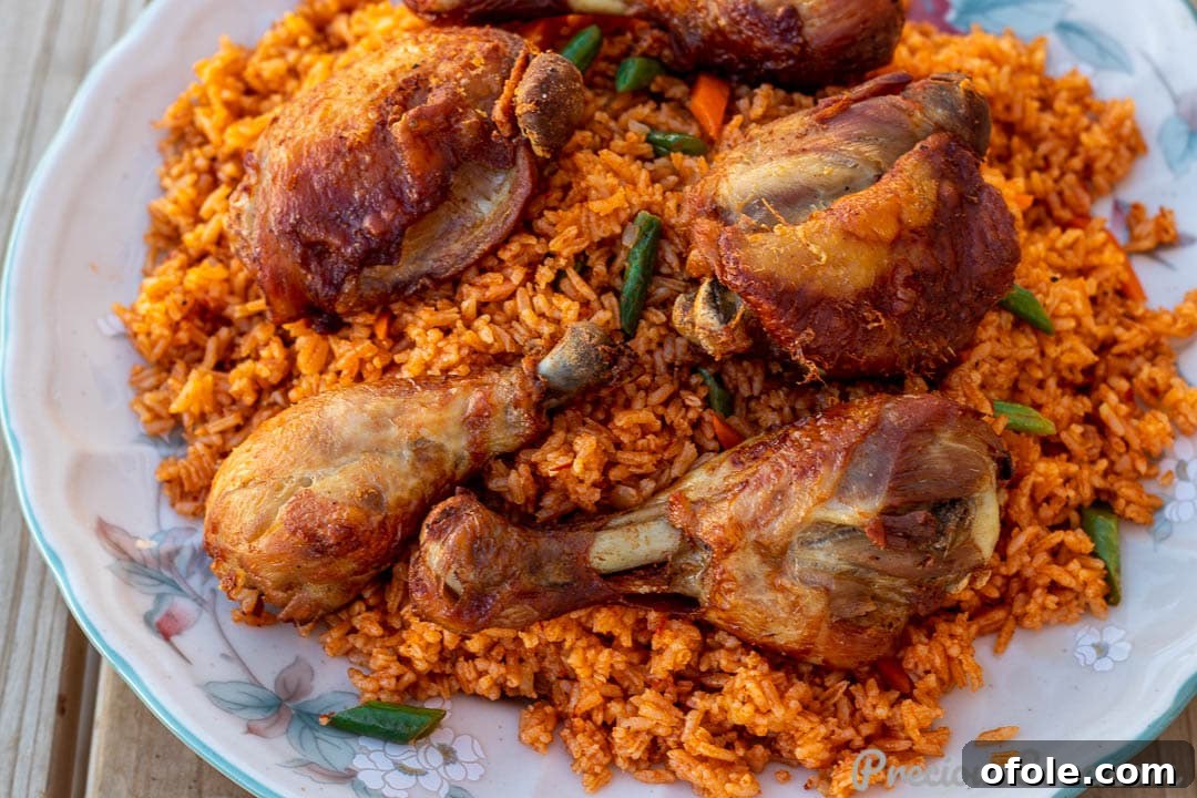 A wide, inviting shot of Jollof Rice simmering beautifully in a large pot, showcasing its vibrant color and texture