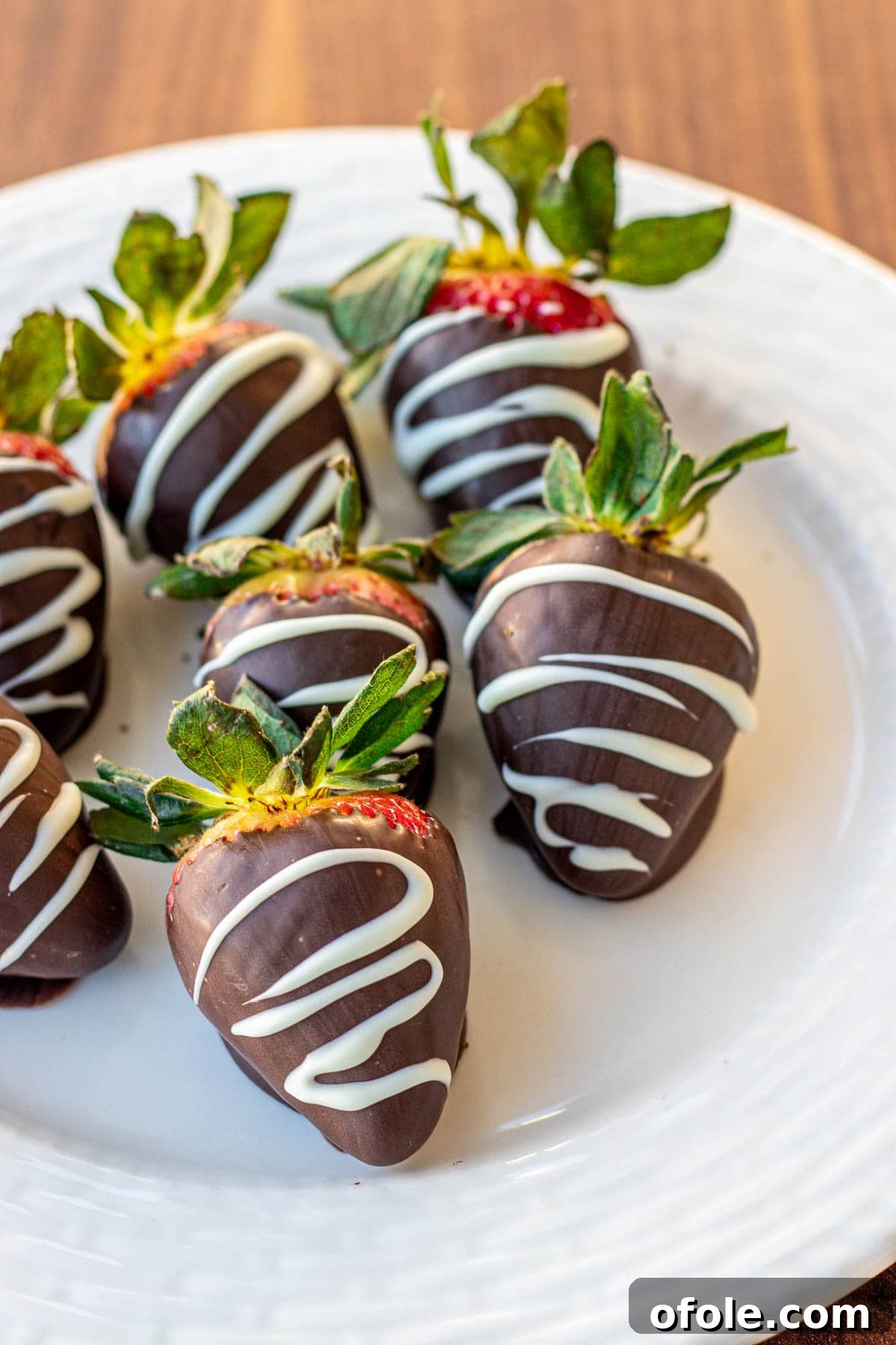 Effortless Chocolate Strawberry Indulgence 11 Decadent chocolate covered strawberries beautifully drizzled with contrasting white chocolate, creating an elegant visual.