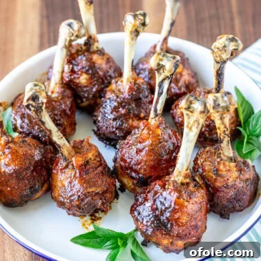 Plated sweet chili baked chicken drumstick lollipops.