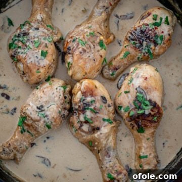 Chicken drumsticks in creamy sauce in a cast iron skillet
