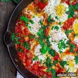 Discover Africa: 20 Irresistible Dinner Recipes 30 Shakshuka, a delicious vegetarian African dinner, prepared in a cast iron pan.