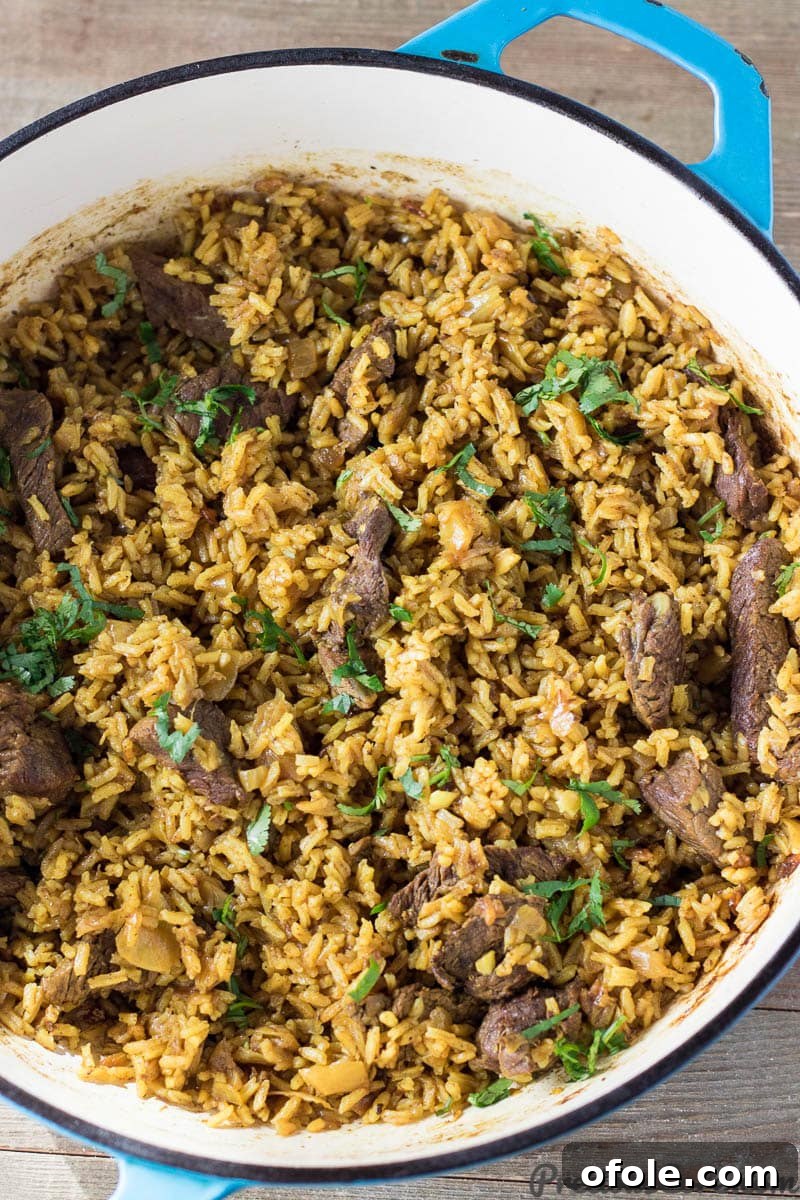 Discover Africa: 20 Irresistible Dinner Recipes 5 Fragrant Pilau rice cooking in a pot, a classic East African dinner recipe.
