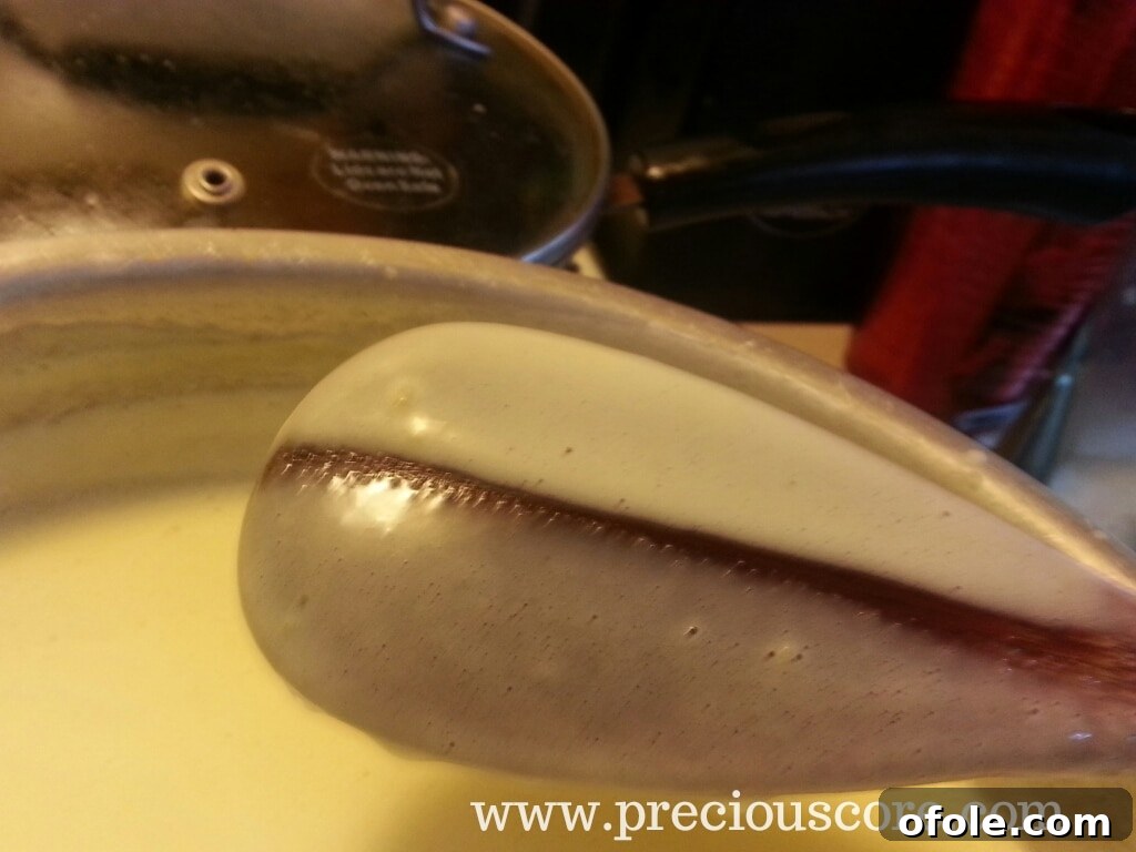 Custard thickening on the stove, coating the back of a wooden spoon