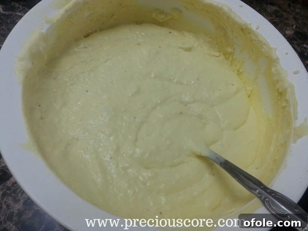 Partially frozen Key Lime Mint Ice Cream being stirred in a container
