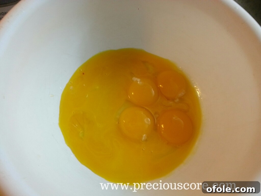 Eight egg yolks in a bowl, awaiting sugar