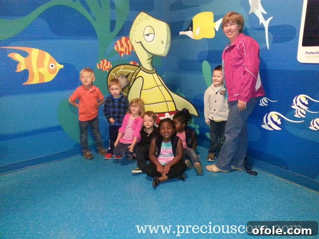 Group photo of schoolchildren and their teacher during the Sea Life Aquarium field trip