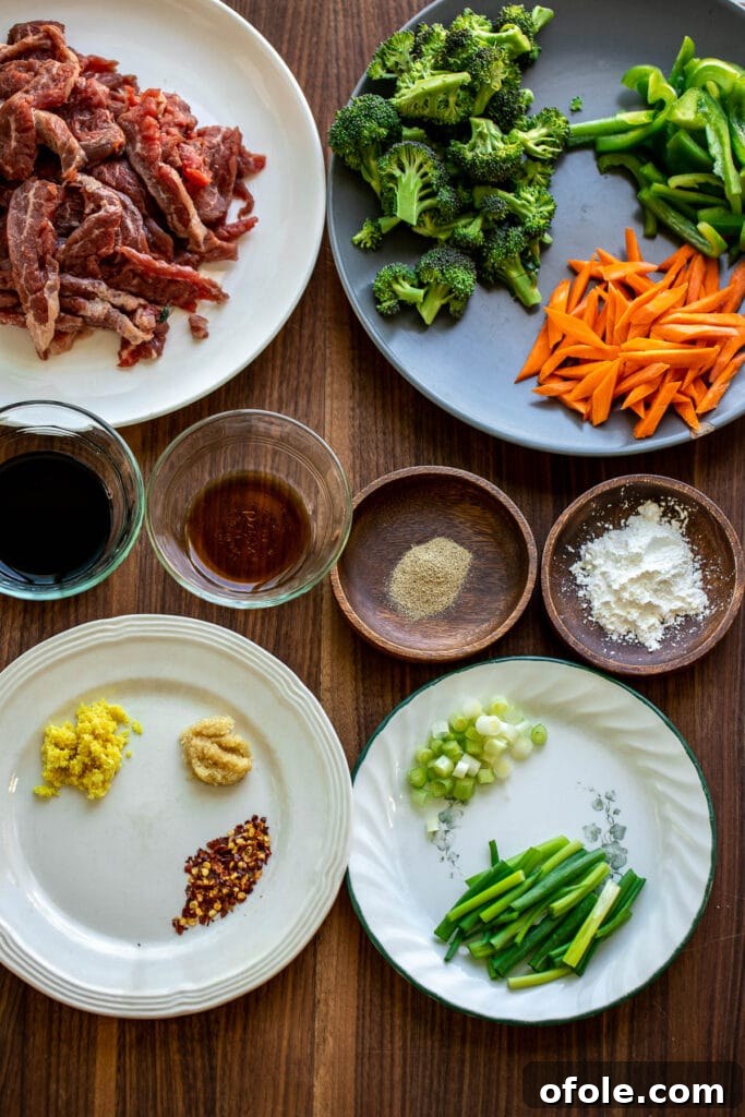 Vibrant Beef and Vegetable Stir-Fry 3 Collection of fresh ingredients for Beef and Vegetable Stir Fry, including sliced beef, fresh broccoli, carrots, bell peppers, garlic, ginger, and sauces.