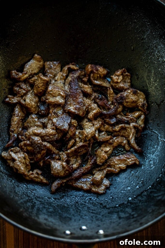 Vibrant Beef and Vegetable Stir-Fry 5 Thinly sliced beef searing in a hot wok, achieving a perfect brown crust
