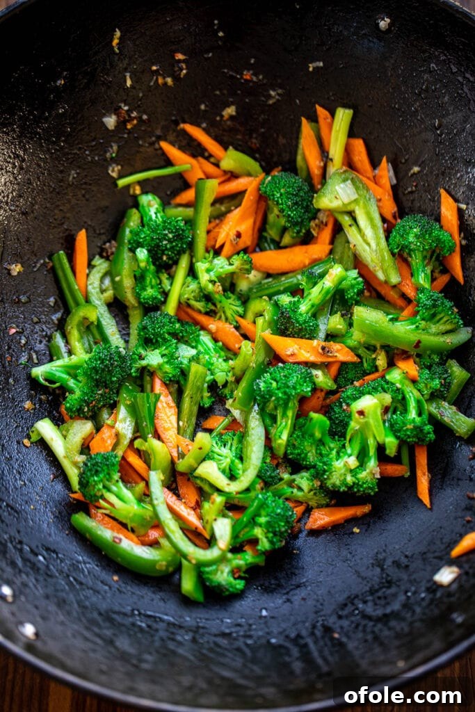 Vibrant Beef and Vegetable Stir-Fry 6 Vibrant mix of broccoli, carrots, and bell peppers stir-frying in a wok