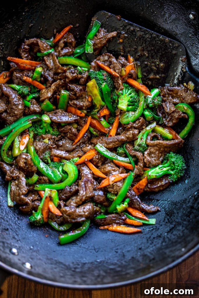 Vibrant Beef and Vegetable Stir-Fry 7 Finished Beef and Vegetable Stir Fry simmering in a wok, coated in a glossy sauce