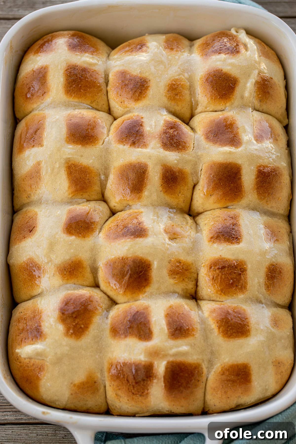 The Ultimate Hot Cross Buns 4 A large pan filled with golden-brown Easter hot cross buns, ready to be served.