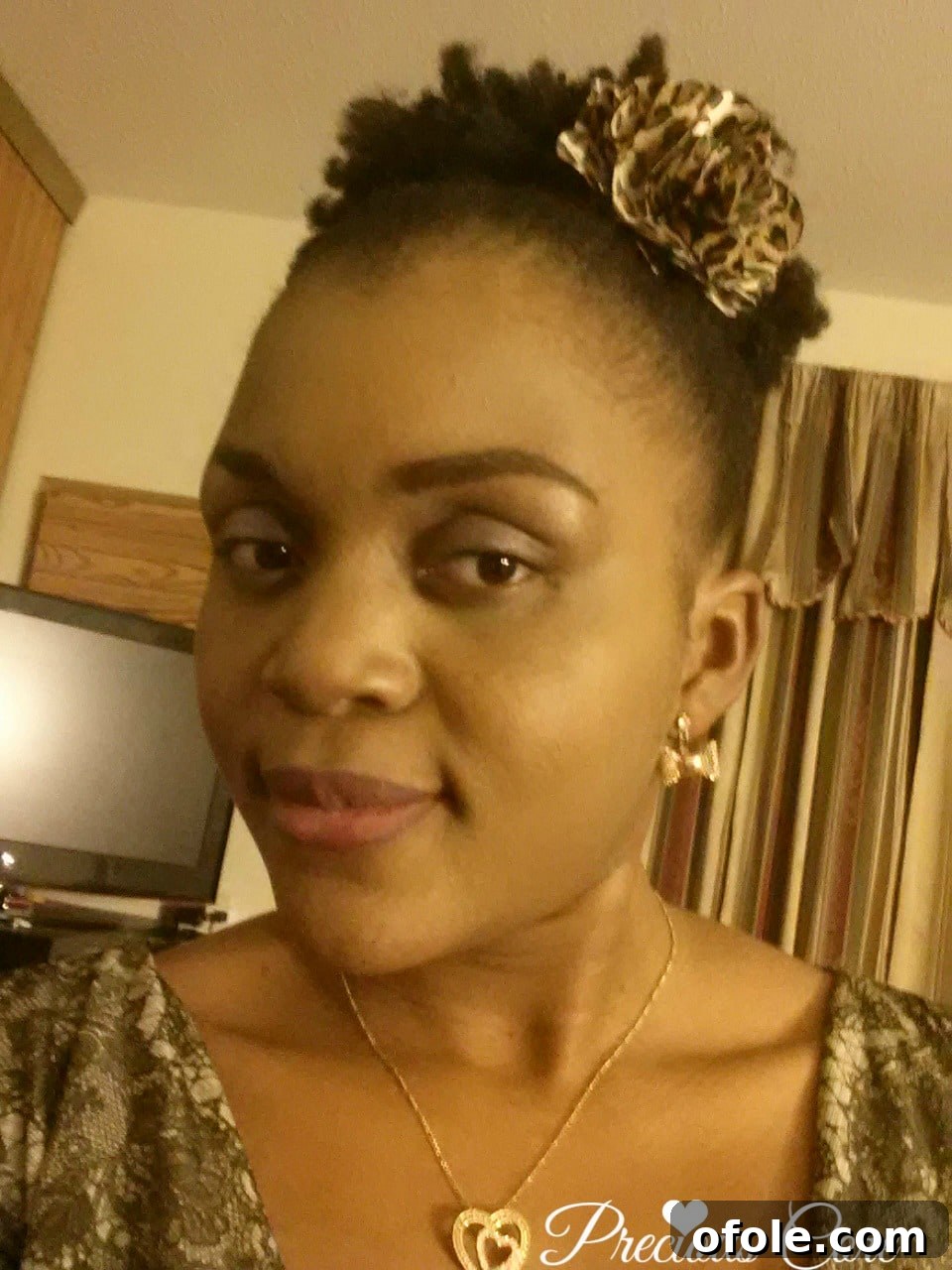 Natural hair high puff style Woman with a sleek high puff natural hairstyle