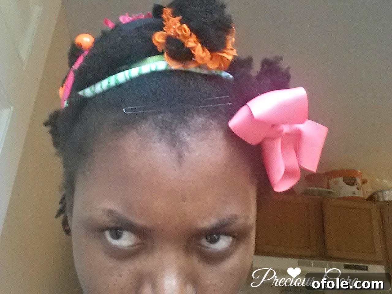 Daughters helping with natural hair styling Child styling mother's natural hair with accessories