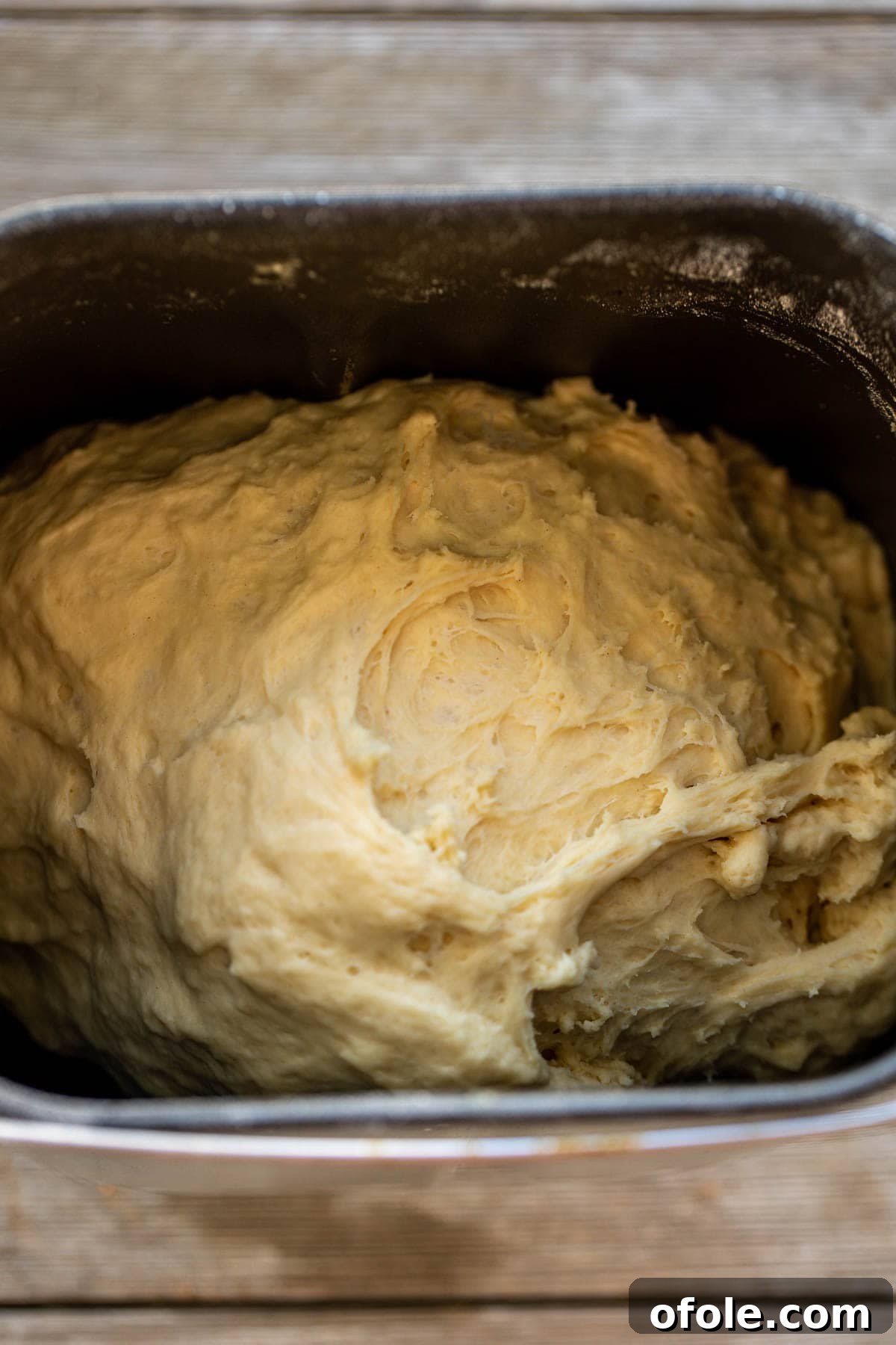 Heavenly Cinnamon Swirls with Tangy Cream Cheese Glaze 6 Cinnamon rolls dough in the bowl of a bread machine.