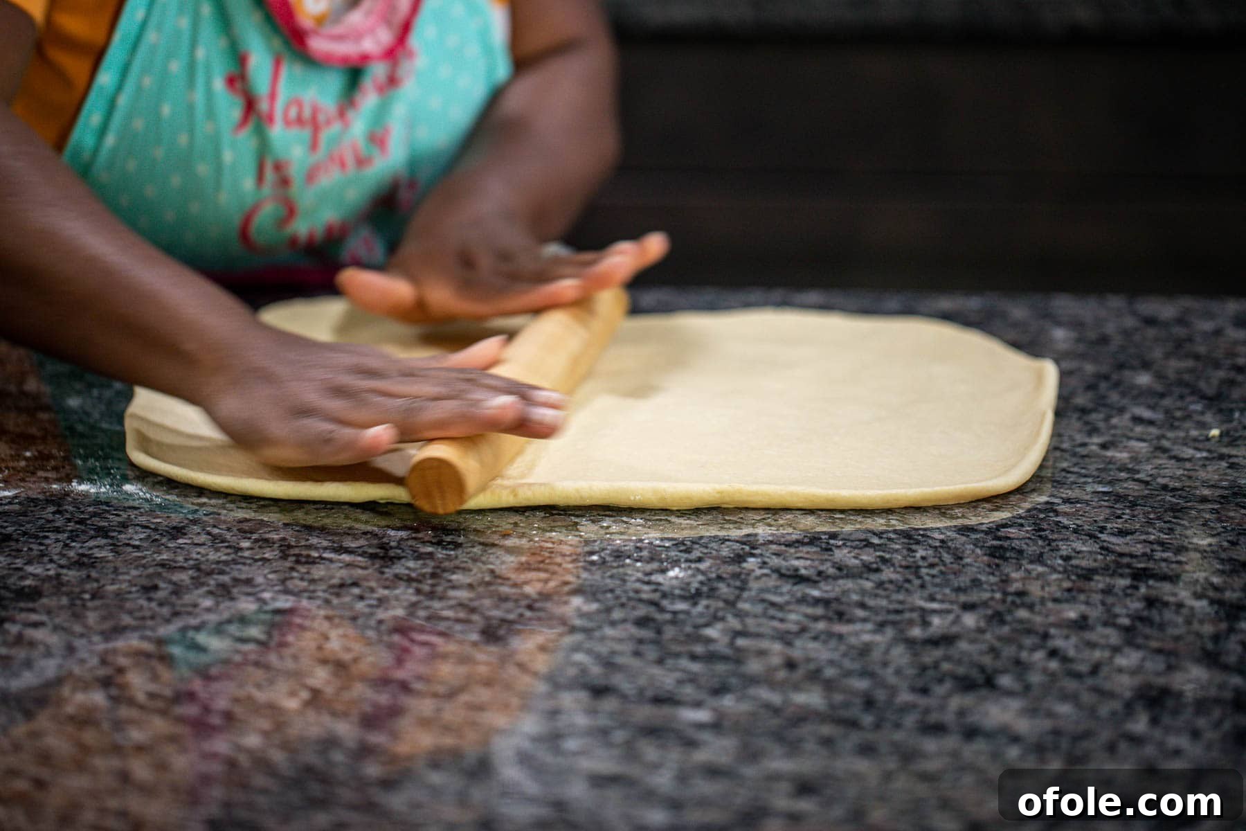 Heavenly Cinnamon Swirls with Tangy Cream Cheese Glaze 7 Hand rolling dough into a rectangle.