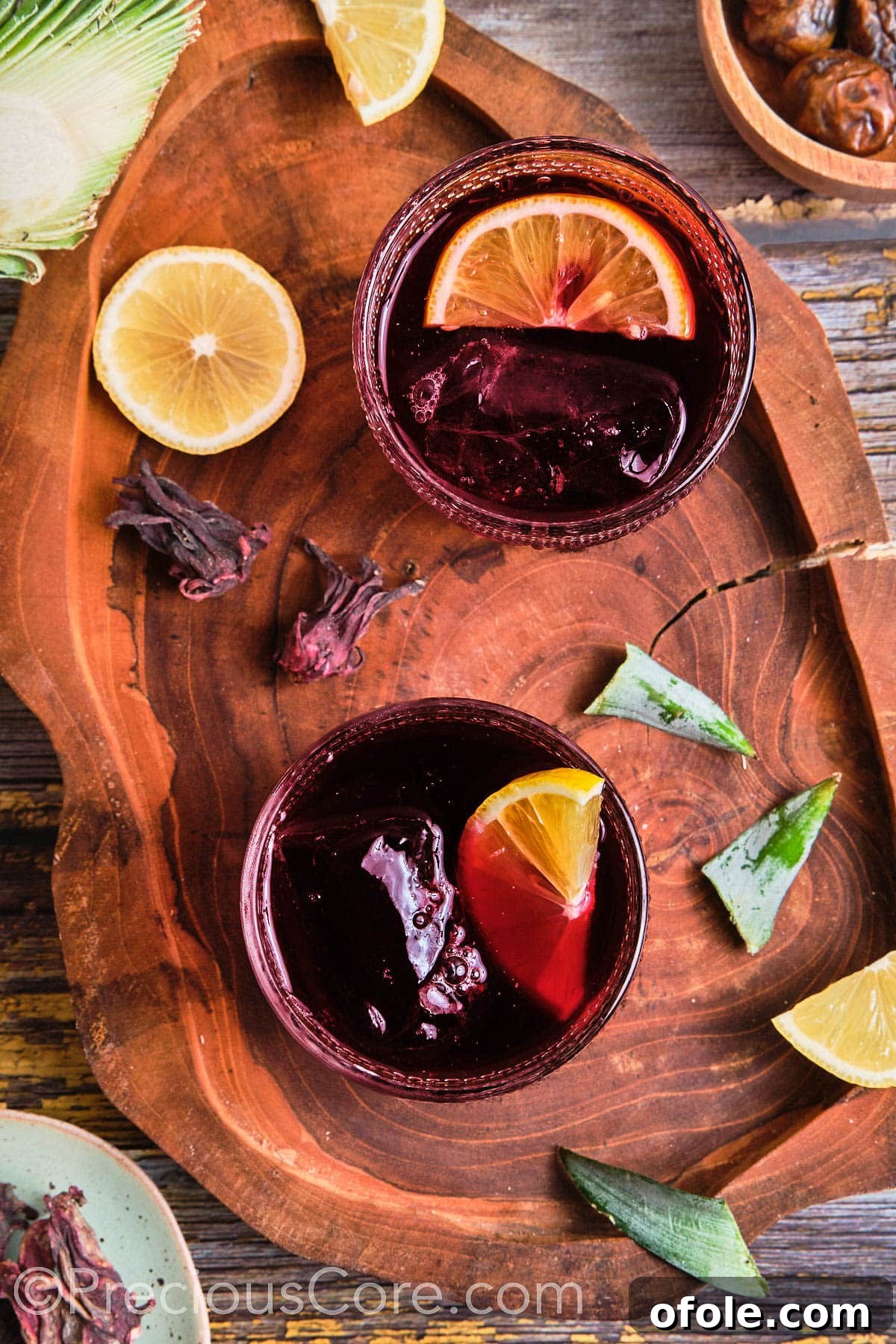 Cameroonian Folere Hibiscus Refresher 11 Glasses filled with vibrant red folere drink, served over ice, and garnished for presentation.
