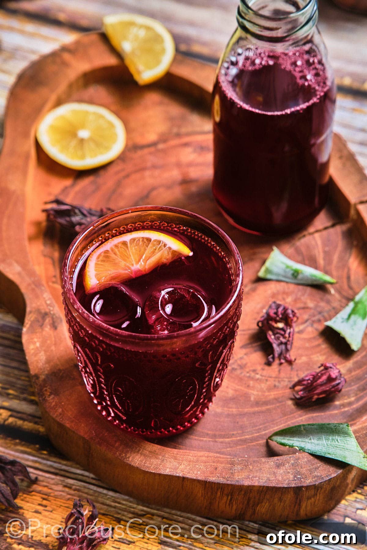 Cameroonian Folere Hibiscus Refresher 3 A glass of Folere drink topped with a vibrant lemon wedge, ready to be enjoyed.
