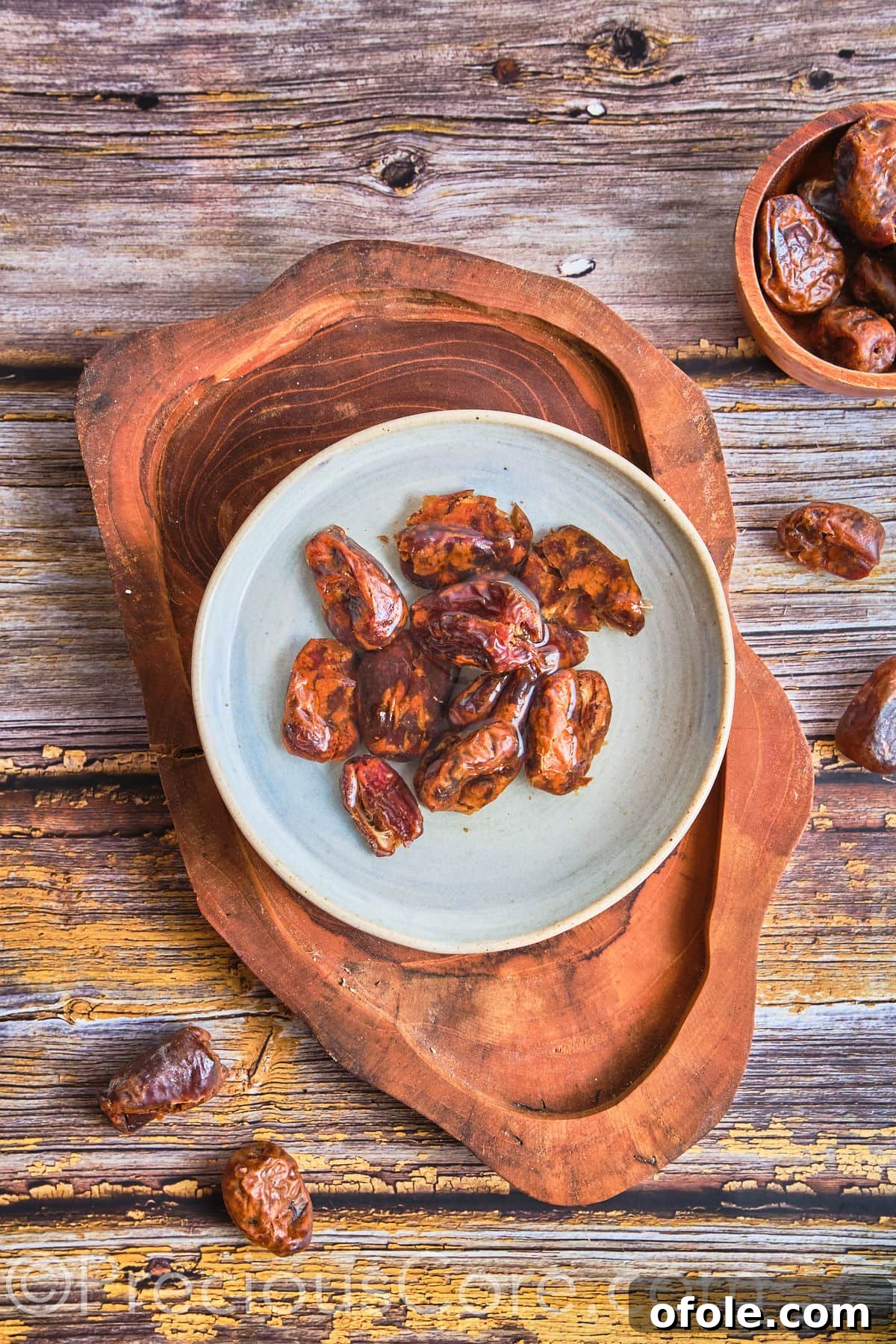 Medjool dates soaking in a bowl of warm water to soften them for blending.