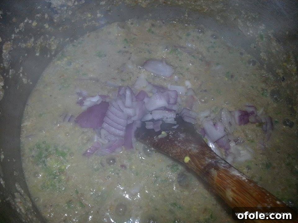 Unlock the Secrets of Delicious Okra Egusi Soup 8 Chopped onions being mixed into the okra-egusi soup for fresh flavor